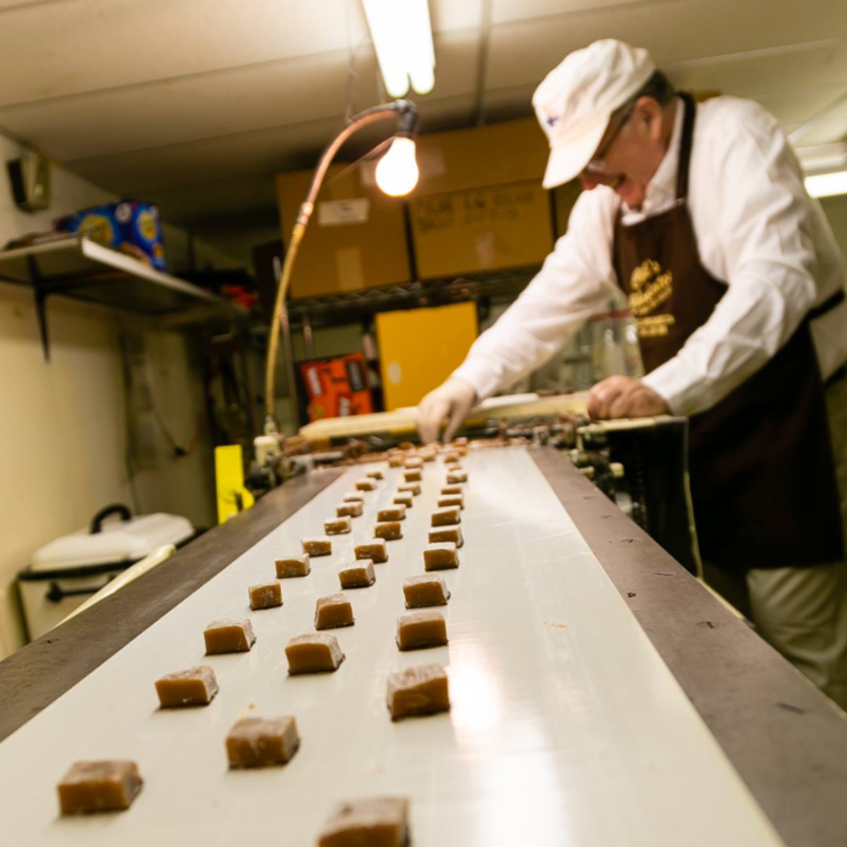 Bob Clark, son of the founders, cutting caramels by hand.