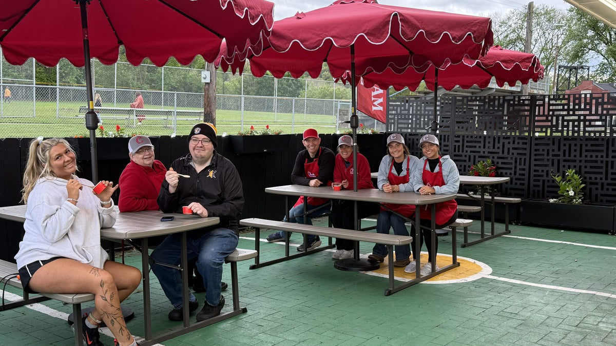 Picnic tables under red umbrellas on the Clark Candies Ice Cream Cafe patio